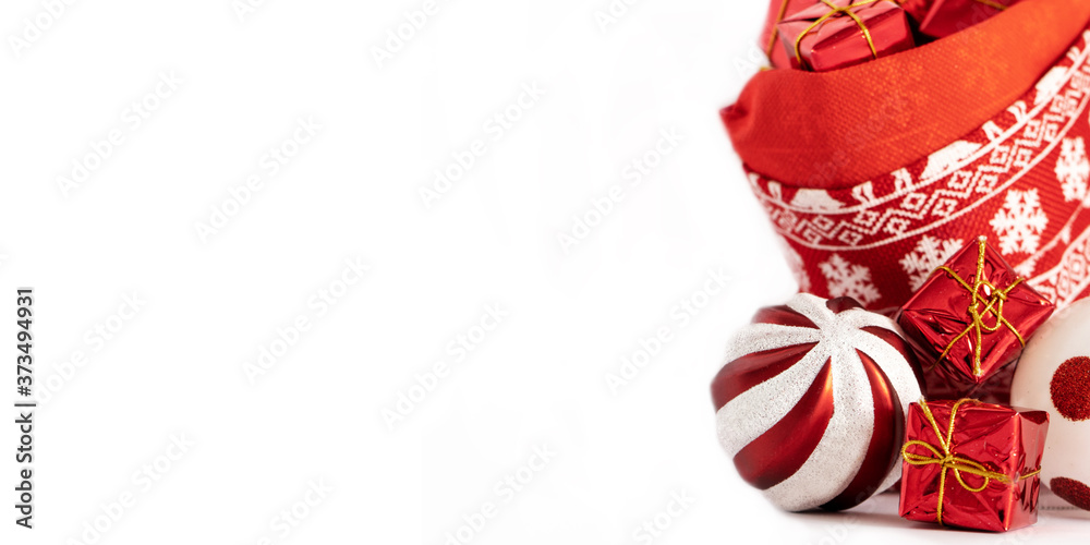 New Year and Christmas concept. Banner. Christmas toys, balls and gift boxes in a decorative bag with deer isolated on a white background.