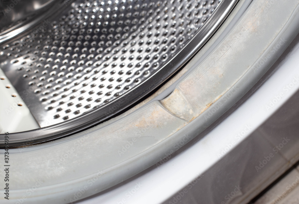 Dirt and fungus from moisture on the sealing gum of the washing machine drum. Washing machine cleanliness and care concept Dirt and fungus from moisture on the sealing gum of the washing machine drum. Washing machine cleanliness and care concept
