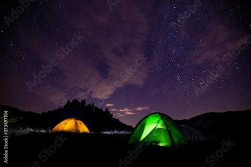 Tents in the night with the milky way. Wanderlust concept. 