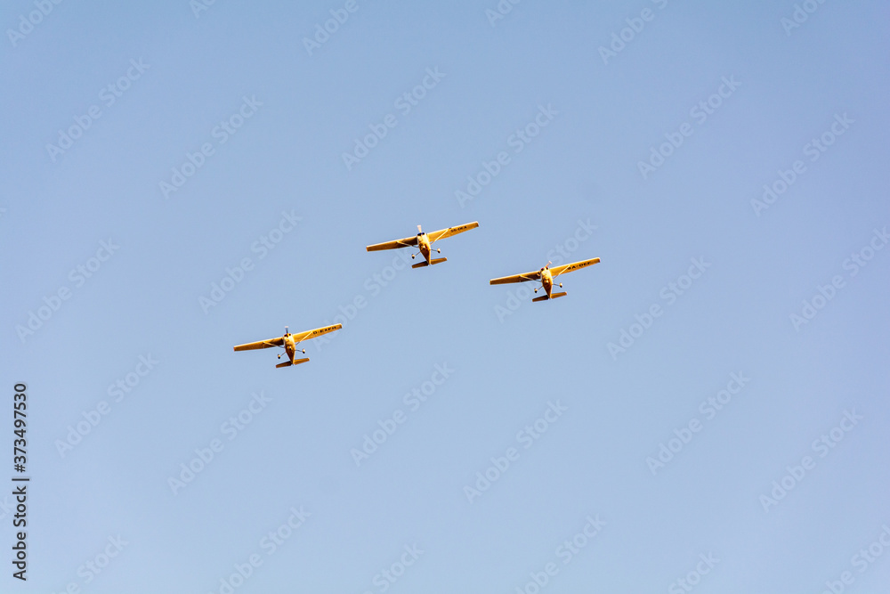 Fototapeta premium Three small planes flying in a formation