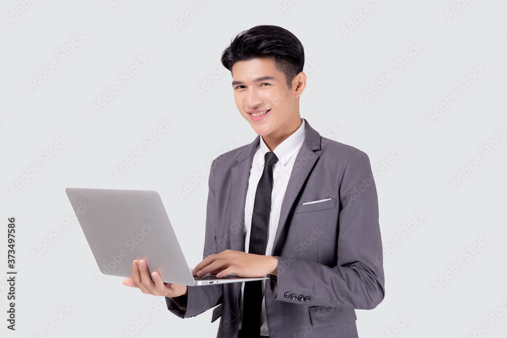 Young asian business man standing work on laptop computer to internet online isolated on white background, businessman confident and notebook, freelance with success, marketing and communication. Young asian business man standing work on laptop computer to internet online isolated on white background, businessman confident and notebook, freelance with success, marketing and communication.