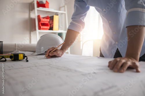 Architect working in office with blueprints,engineer thinking and planning inspection in workplace for architectural plan,sketching a construction project,Business construction concept. photo
