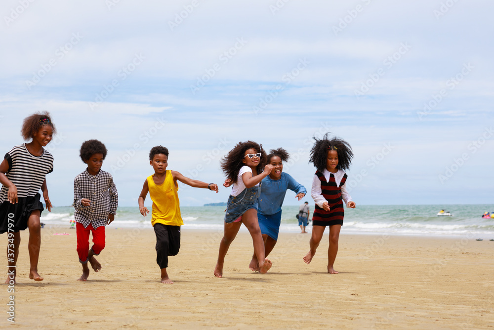 Group of African kid playing joyful on the beach together after unlockdown beach after covid-19 crisis
