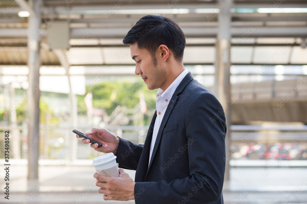 Young businessman use smartphone in the city. Concept businessman. Young businessman use smartphone in the city. Concept businessman.
