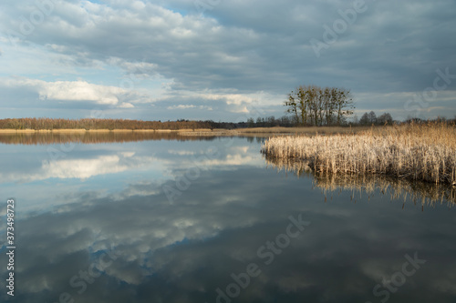 The reflection of dark clouds in a peaceful lake