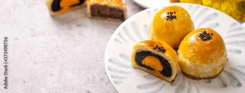 Canvas Print Tasty baked egg yolk pastry moon cake for Mid-Autumn Festival on bright cement table background