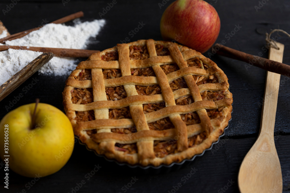 Homemade lattice Apple pie with cinnamon on an old textured wooden background Homemade lattice Apple pie with cinnamon on an old textured wooden background