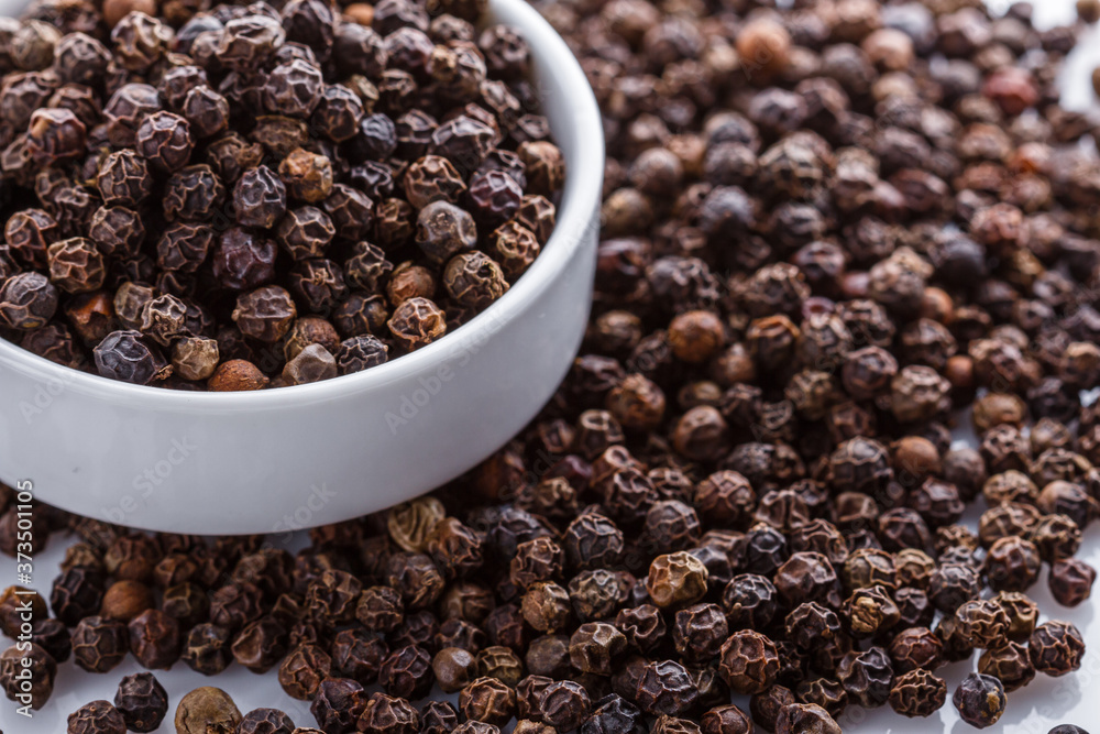 fragrant black pepper on white acrylic background fragrant black pepper on white acrylic background