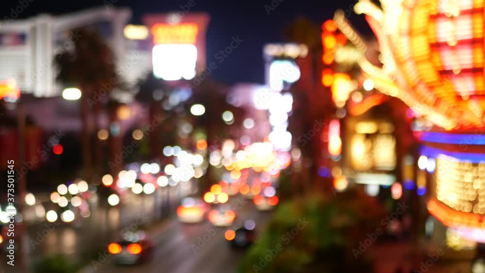 Defocused fabulous Las Vegas Strip boulevard, luxury casino and hotel, gambling area in Nevada, USA. Nightlife and traffic near Fremont street in tourist money playing resort. Neon lights of sin city.