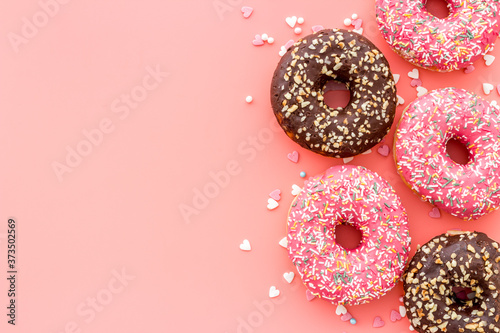 Top view of colorful glazed donut swith sprinkles, copy space