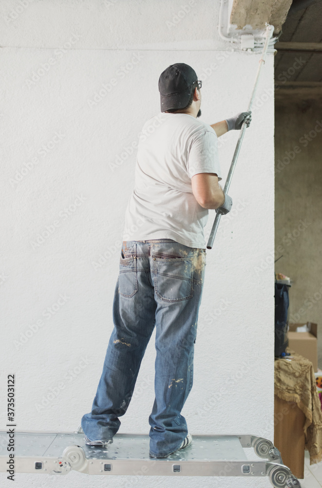 Man painting garage in realistic scene
