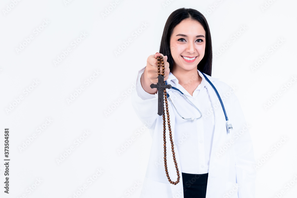 Portrait and Blurred soft images of Asian attractive doctor woman holding a cross, On white background, concept to Healing, sickness and faith Portrait and Blurred soft images of Asian attractive doctor woman holding a cross, On white background, concept to Healing, sickness and faith