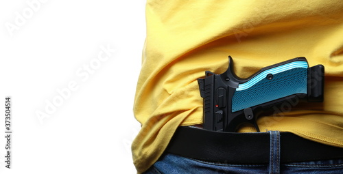 Man conceal carry pistol in jeans isolated on white background photo