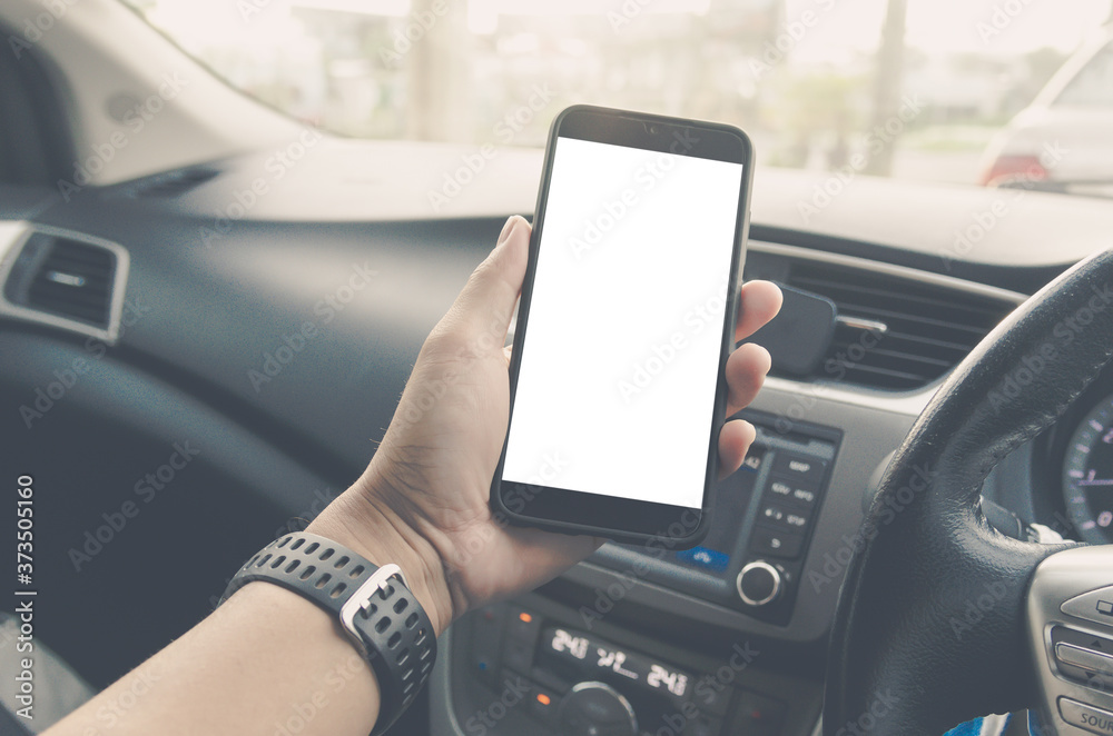 Man hand holding smart phone in car. Mock up blank white screen mobile  phone , searching location  gps navigator.Clipping path