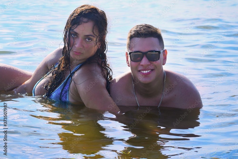 portrait of a young couple in the beach portrait of a young couple in the beach