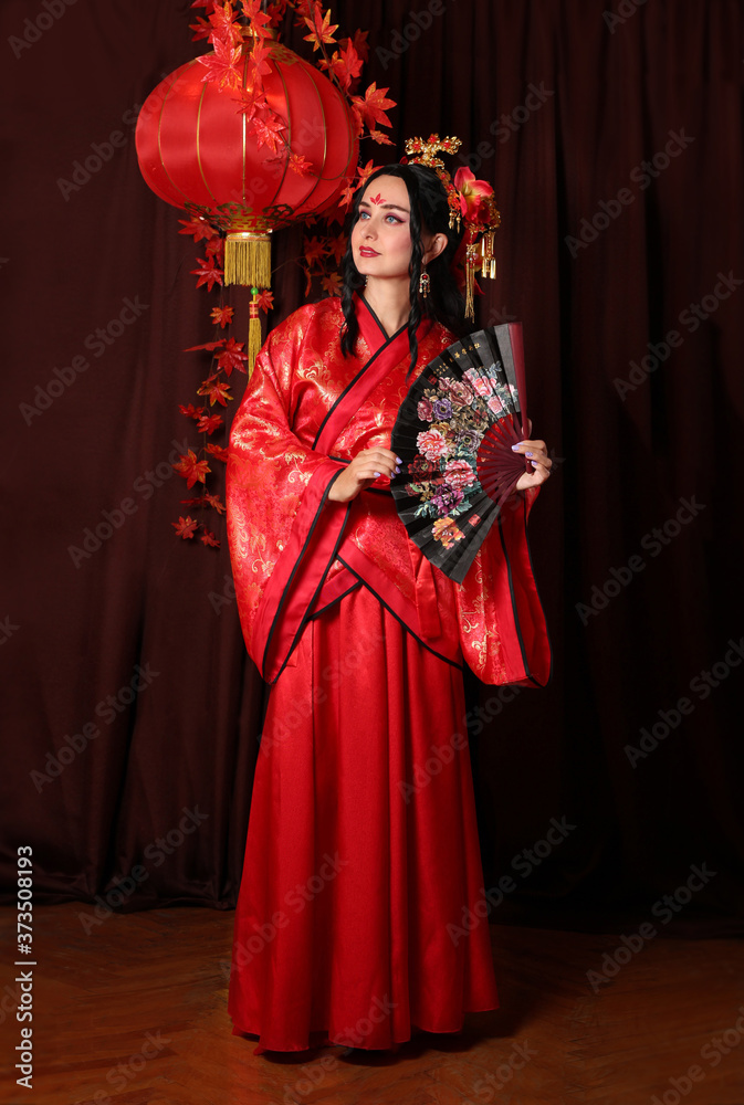 a woman in red Chinese national traditional costume. Chinese woman with hairpins in her hair.
girl with umbrella
girl with a Chinese fan
red Chinese lantern
