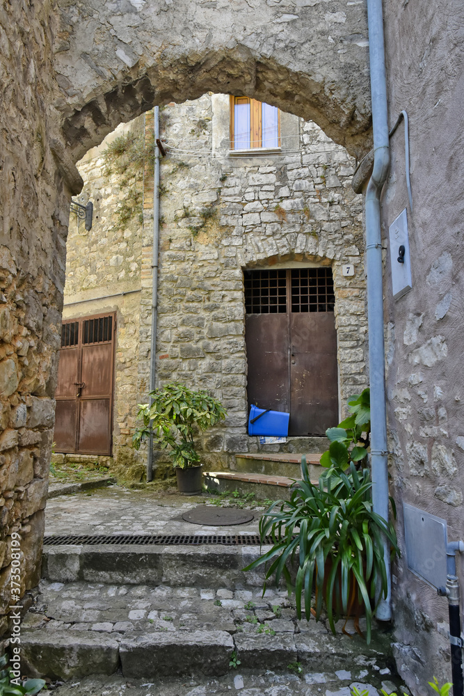 A narrow street among the old houses of Lenola, a medieval village in the Lazio region. A narrow street among the old houses of Lenola, a medieval village in the Lazio region.