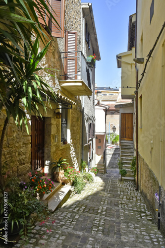 Fototapeta Naklejka Na Ścianę i Meble -  A narrow street among the old houses of Lenola, a medieval village in the Lazio region.