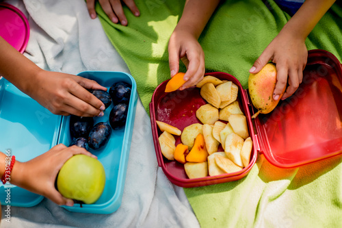 Close up of school children holding healthy snack