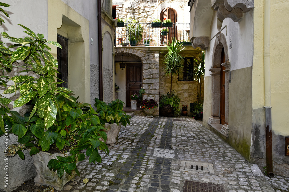 Fototapeta premium A narrow street among the old houses of Lenola, a medieval village in the Lazio region.