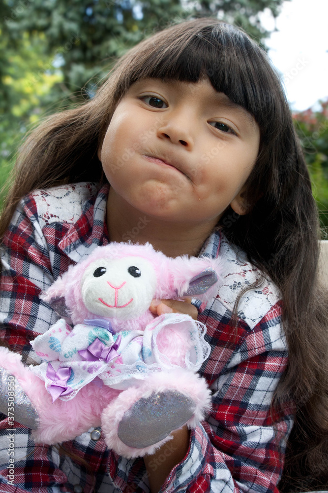 Portrait of a cute happy girl hugging plush toy Portrait of a cute happy girl hugging plush toy