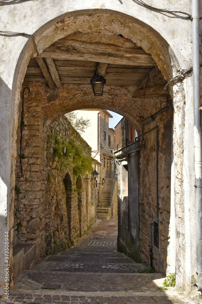 A narrow street among the old houses of Lenola, a medieval village in the Lazio region.