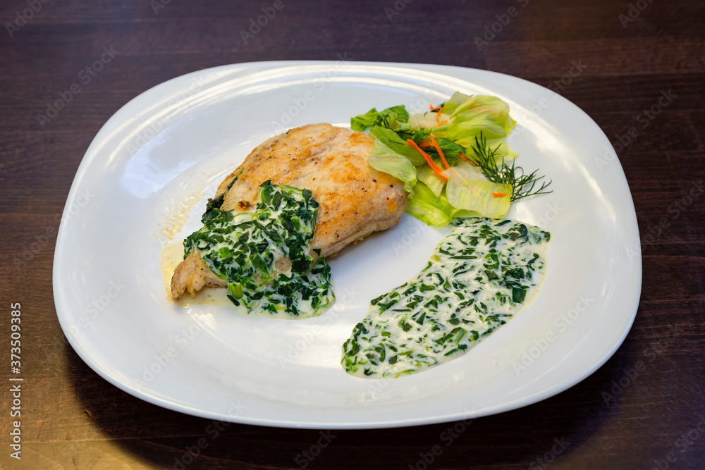 baked chicken breast drizzled with cream sauce with herbs and salad on a white plate on a wooden surface. Healthy food. Side view
baked chicken breast drizzled with cream sauce with herbs and salad on a white plate on a wooden surface. Healthy food. Side view