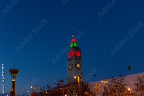 The Ferry building at the end of the street illuminated at night photo