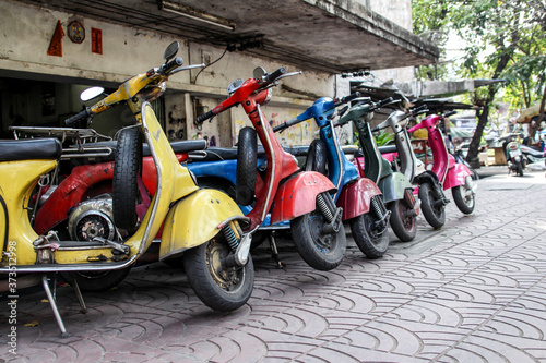 colorful vintage scooters parked in the street