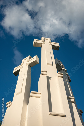 The Three Crosses monument overlooking Vilnius Old Town on sunset. Vilnius landscape from the Hill of Three Crosses, located in Kalnai Park, Lithuania. photo