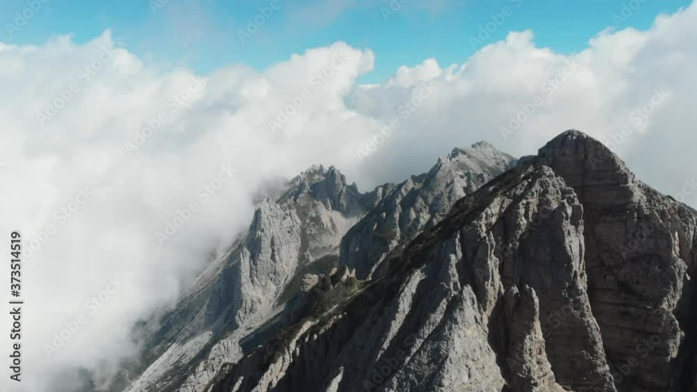 Aerial view of the Alps in the Trentino region (Italy), with fog and sun. A beautiful summer day, perfect for trekking. Aerial view of the Alps in the Trentino region (Italy), with fog and sun. A beautiful summer day, perfect for trekking.