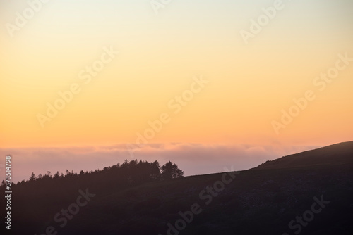 Majestic landscape image at sunset over Dartmoor National Park in Engand with beautiful soft pastel colors