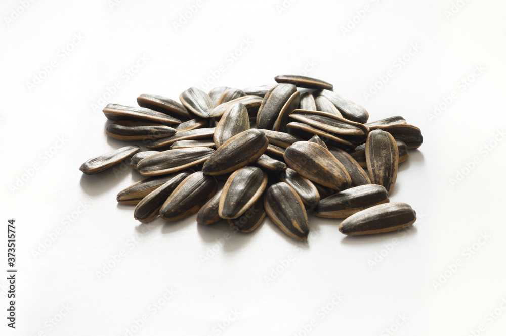 Pile of Sunflower seeds on white background. Pile of Sunflower seeds on white background.