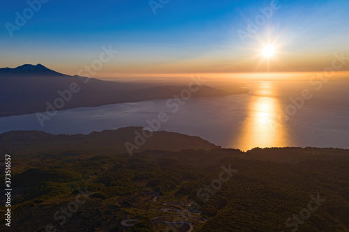 sunset with haze at the top of the Vicente Perez Rosales national park with view to the native forest, llanquihue lake and Calbuco volcano