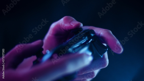 Playing video games close up with a black background