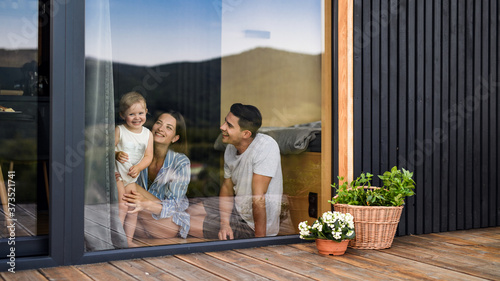 Young family with small daughter indoors, weekend away in container house in countryside. photo