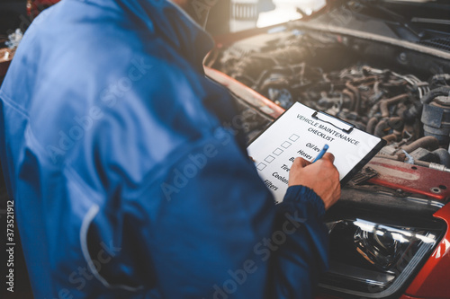 Car mechanic inspecting vehicle. Auto inspection concept
