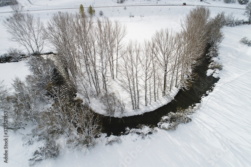 snowy curve of river from aerial view photo