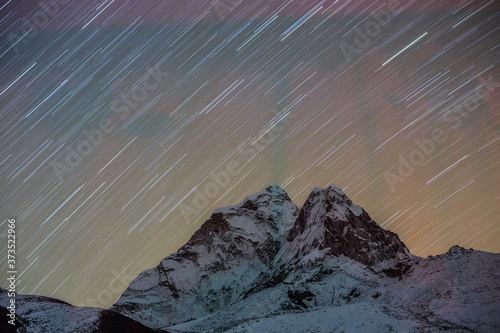 Star trails captured in a long exposure image of Ama Dablam in Nepal.