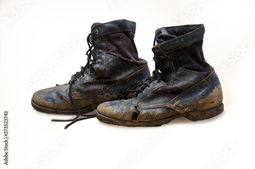 Old and torn boots isolated on white background