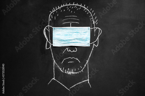 Obraz na płótnie Chalkboard drawing: a man wearing a medical eye mask w salonie