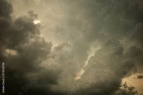 Dark yellow-gray clouds in a turbulent sky