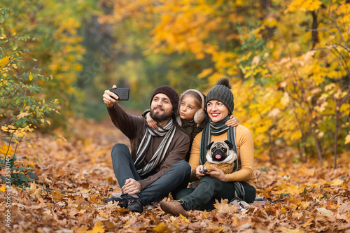 holidays, vacation, travel and tourism concept - group of friends or couples having fun in autumn park and taking selfie