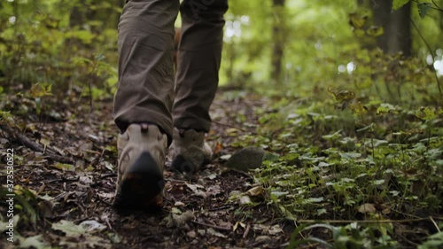 A hiker and his dog in the woods 
