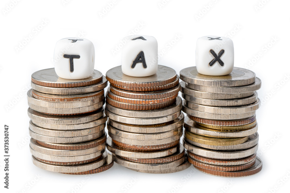 TAX alphabet on stack of coins from salary payment income for office employee worker. TAX alphabet on stack of coins from salary payment income for office employee worker.