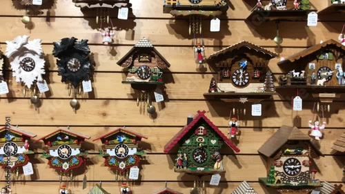 A wooden wall full of German handcrafted cuckoo clocks.