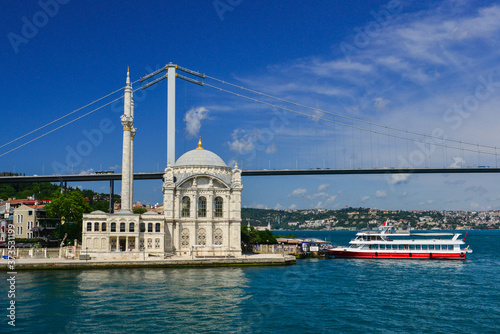 Istanbul cityscape, including Bosphorus bridge and Ortakoy Mosque as seen from a passenger boat - Istanbul, Turkey 