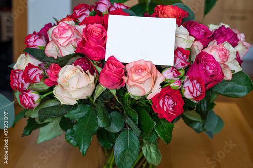 Bouquet of red  pink and yellow roses with empty card. Template for birthday  wedding  mother day  valentine day card.