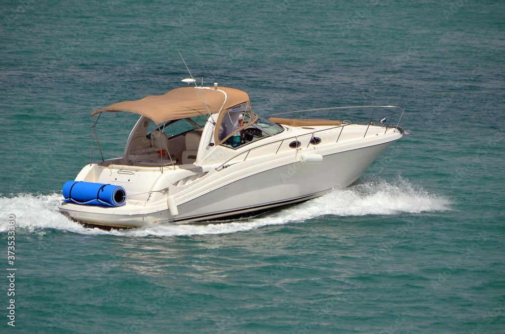 High-end cabin cruiser on the Florida Intra-Coastal Waterway off of Miami Beach. High-end cabin cruiser on the Florida Intra-Coastal Waterway off of Miami Beach.