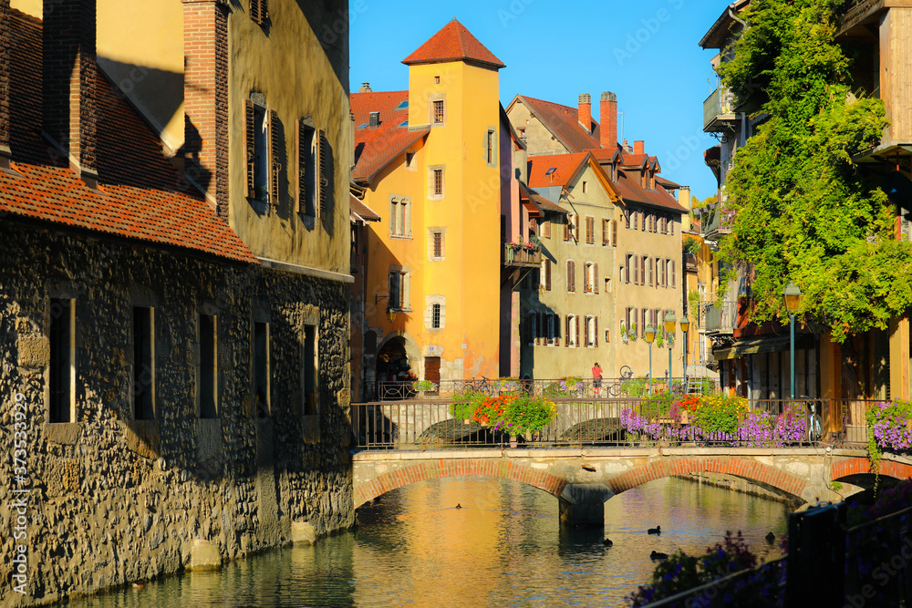 Colorful medieval houses reflected in water of the canal in Annecy, France